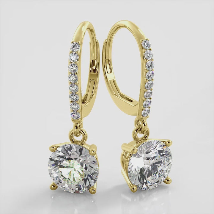 18K Yellow Gold, Classic Brilliant Diamond Drop Earrings with a secure lever back locking mechanism and sparkling round diamonds. These earrings will add a touch of glamour to any outfit. Elevate your style and make a statement with these stunning earrings.